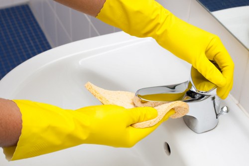 Professional cleaner using protective measures during a cleaning task